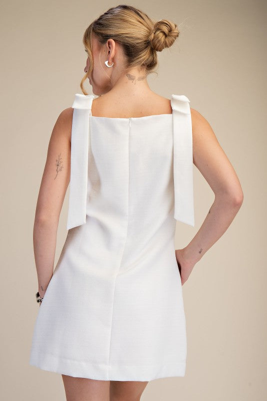 THE KYRA BOW MINI DRESS (WHITE) AVAILABLE OCT 5,2026